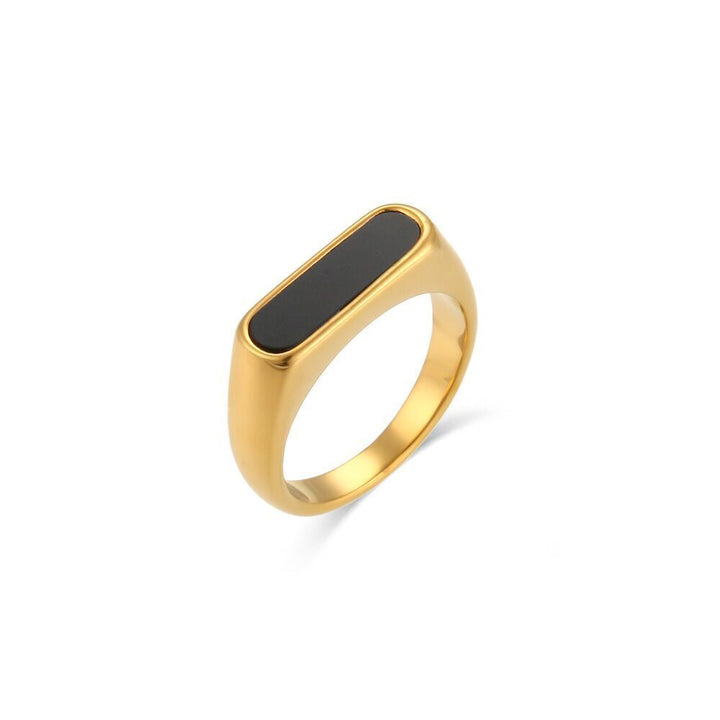 Gold Black Signet Ring with an elongated black inlay, front view on white