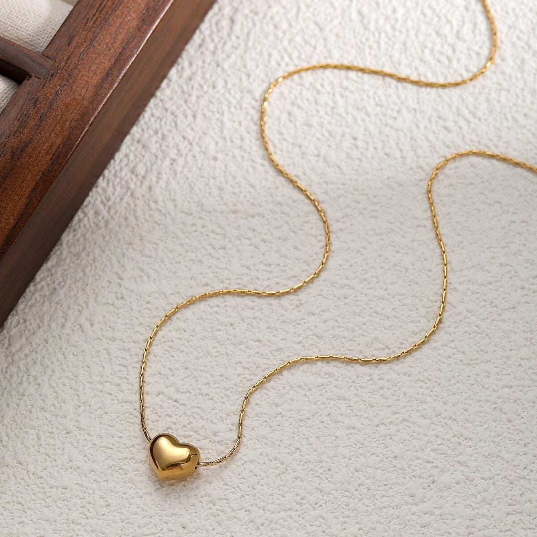 Full length of the Gold Mini Heart Necklace laid flat