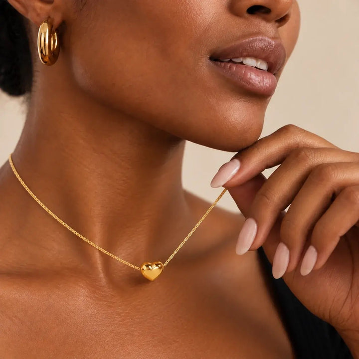 Gold Mini Heart Necklace worn at the collarbone, close-up