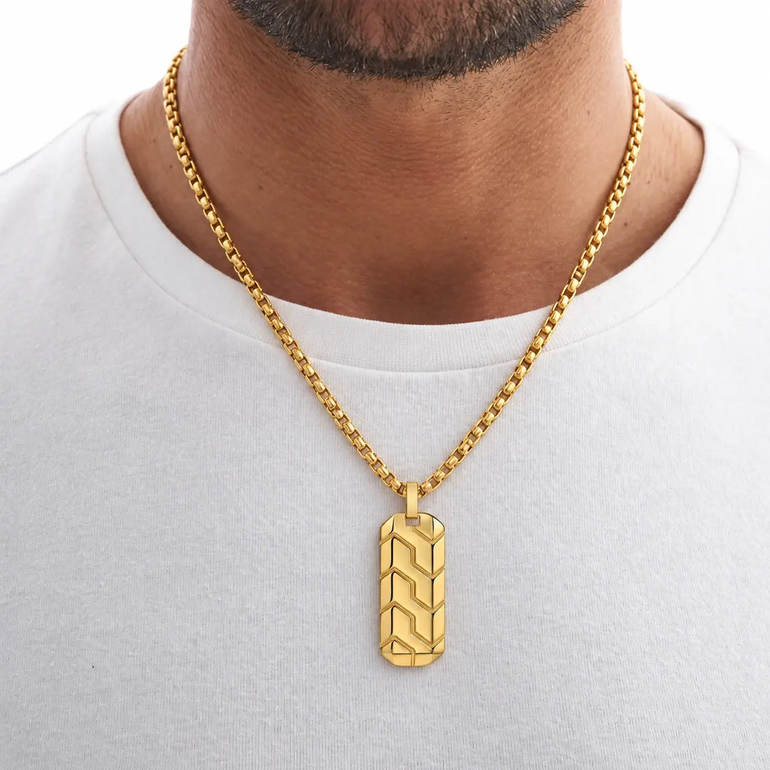 Man wearing the Gold Chevron Pendant over a white T-shirt