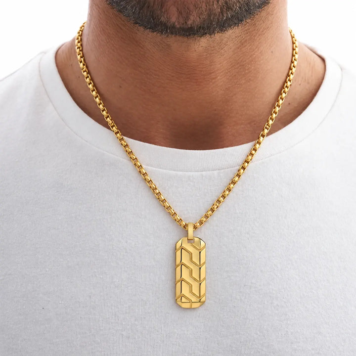 Man wearing the Gold Chevron Pendant over a white T-shirt
