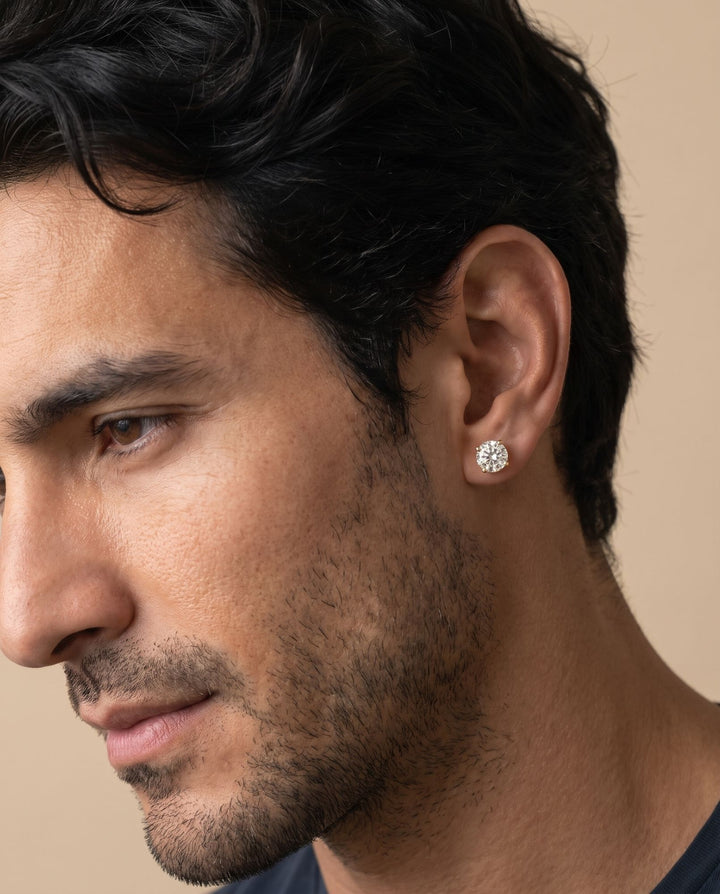 Close-up profile of a man wearing the gold stud with a round simulated diamond