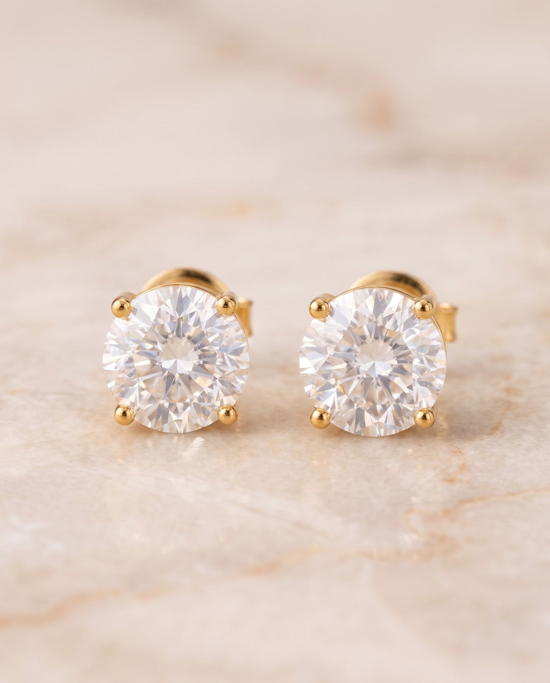 Pair of 6mm gold stud earrings for men with round simulated diamonds, front view