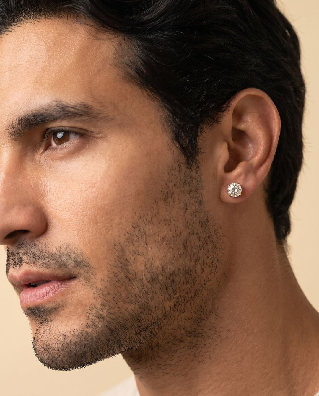 6mm gold stud earring worn on the earlobe of a male model, showing true size