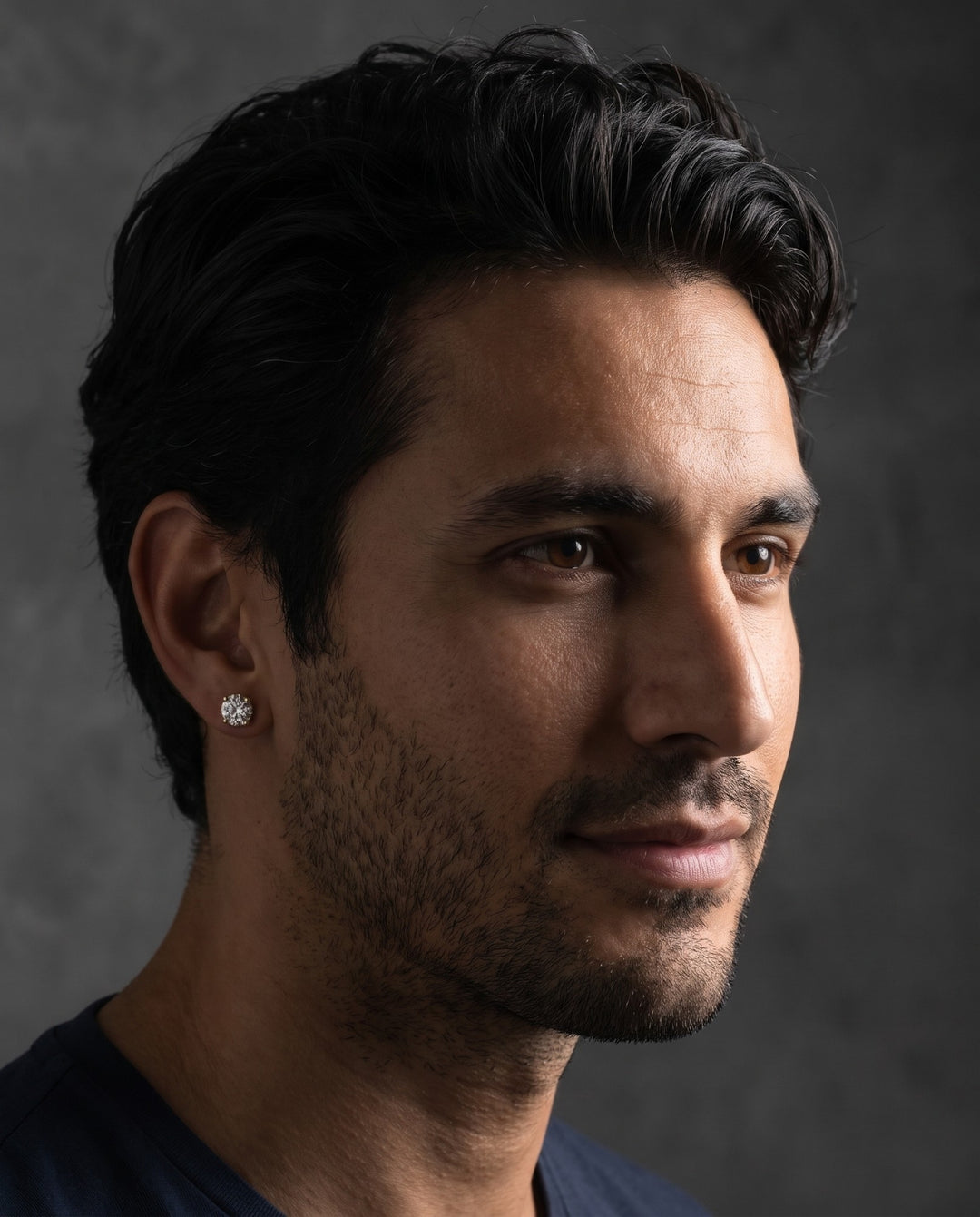 Studio portrait of a man wearing the gold stud earring