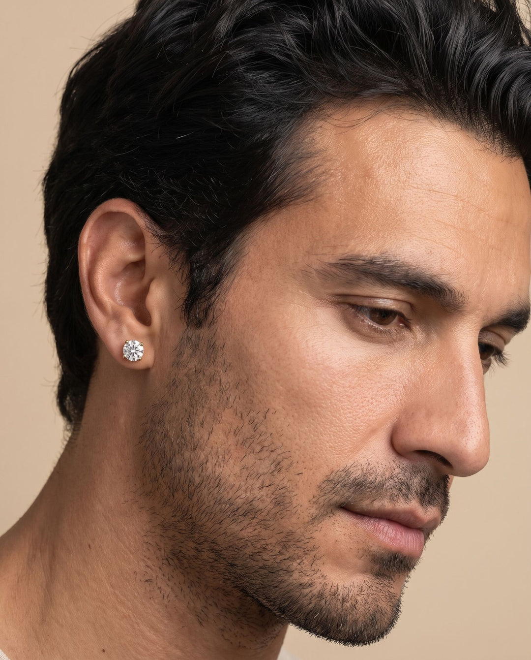 Man looking down wearing the 6mm gold stud earring