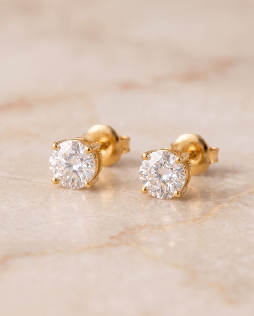 Angled view of the gold studs for men showing the four-prong basket and push-back