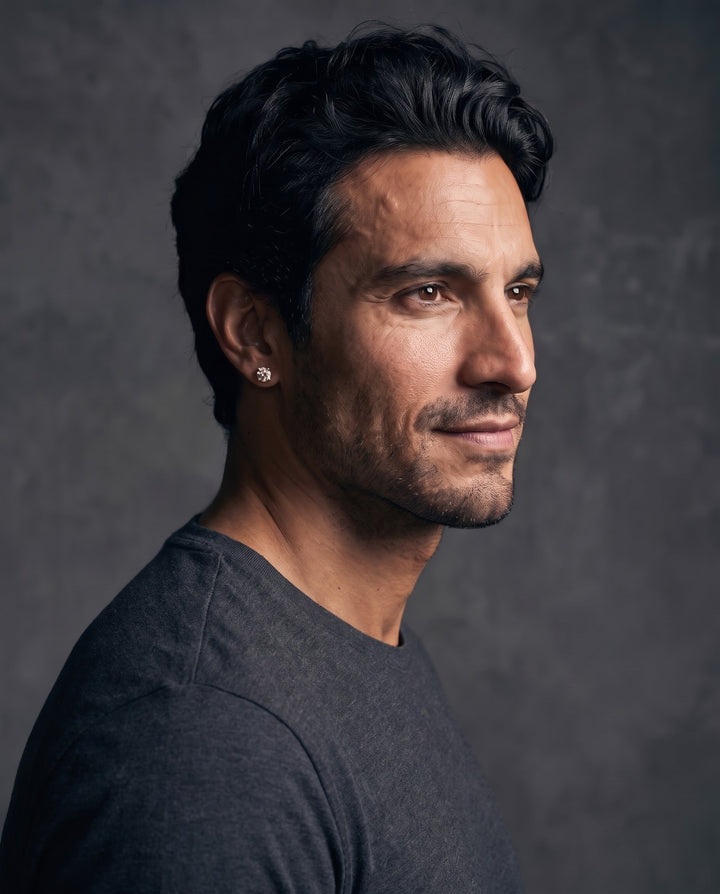 Man in a grey tee wearing the 6mm gold stud earring, side profile