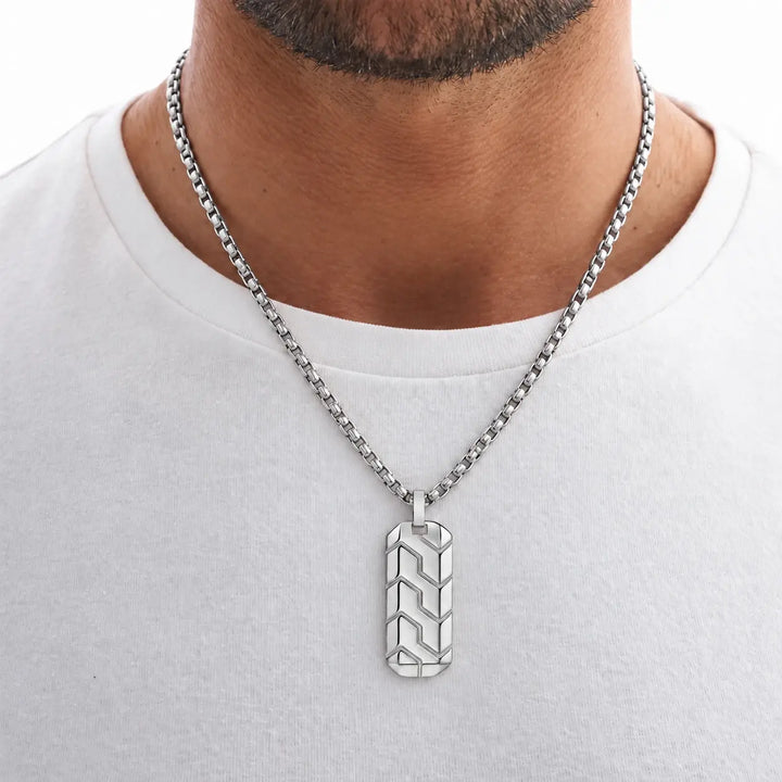 Man wearing the White Gold Chevron Pendant over a white T-shirt